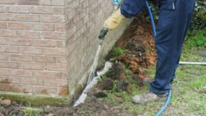 Professional anti-termite soil treatment around a building
