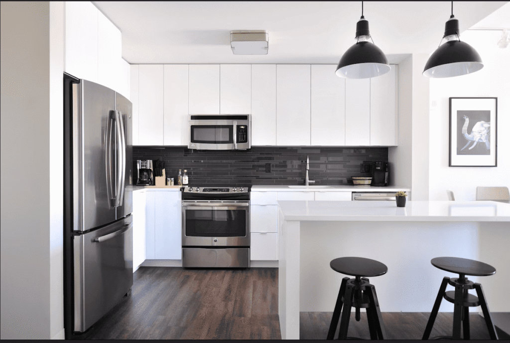 Termite infestation in a newly constructed apartment showing damage to wooden interiors and modular kitchen cabinets in an Indian home.