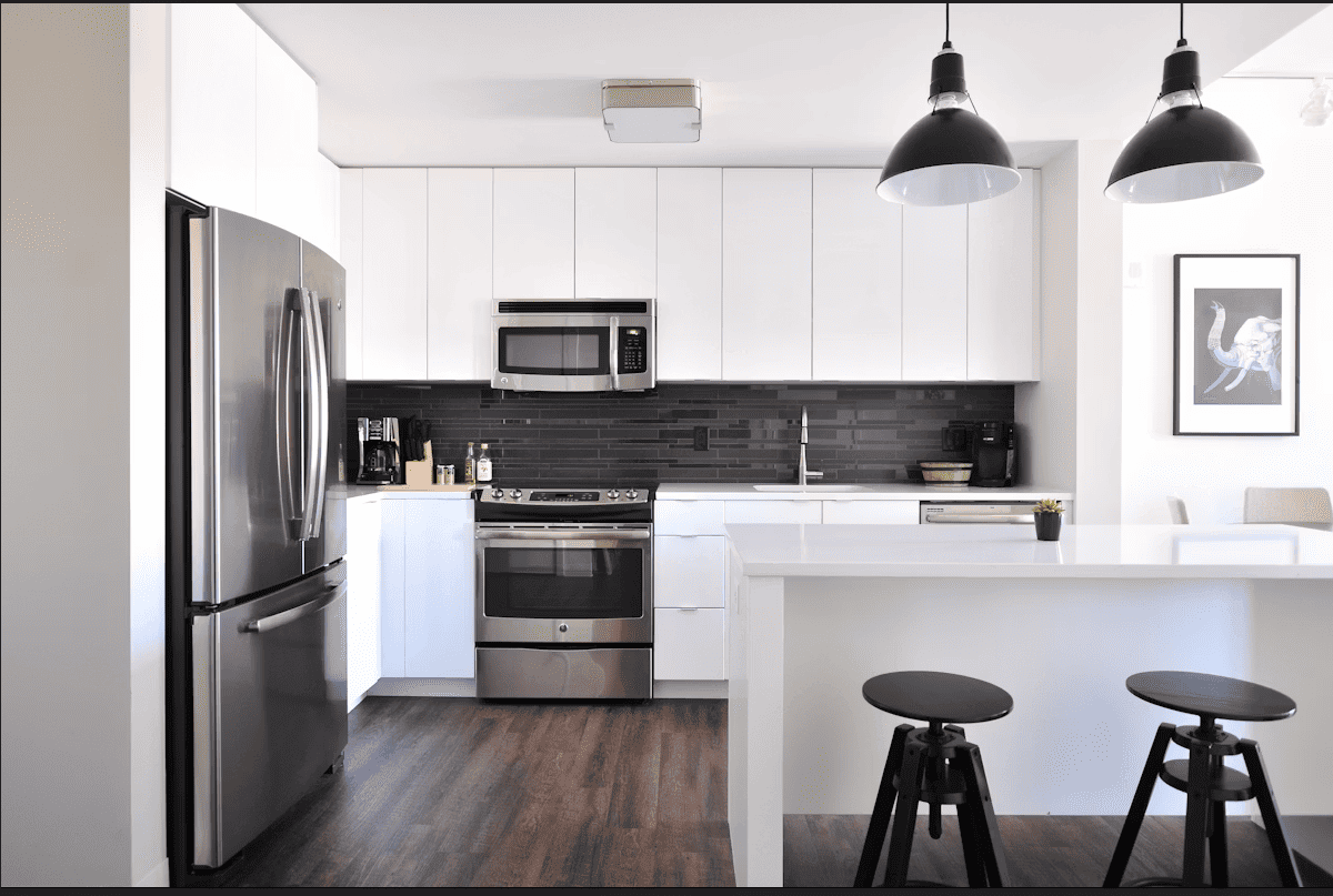 Termite infestation in a newly constructed apartment showing damage to wooden interiors and modular kitchen cabinets in an Indian home.